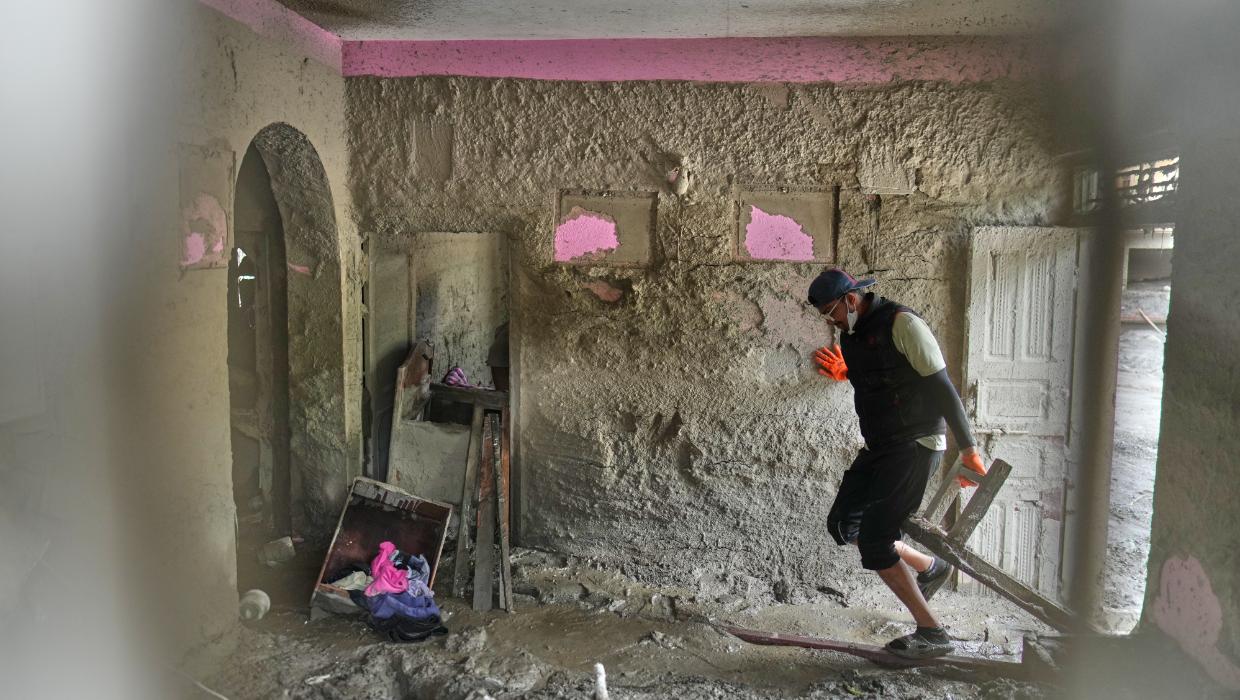People salvage their belongings from homes and schools after flooding in Nepal and Tibet, in photos