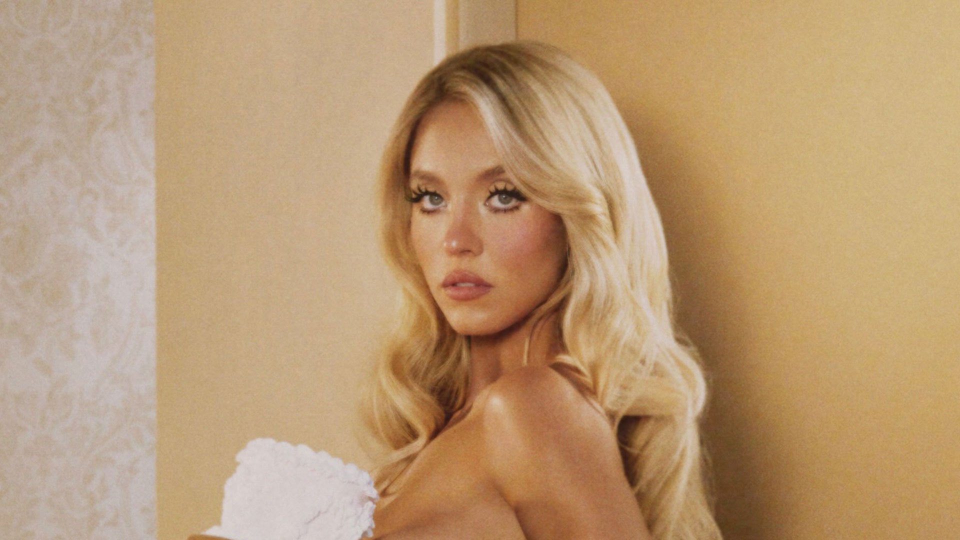 Sydney Sweeney goes topless in just a pink ruffle thong and CAKE in Syrn’s latest steamy photo drop