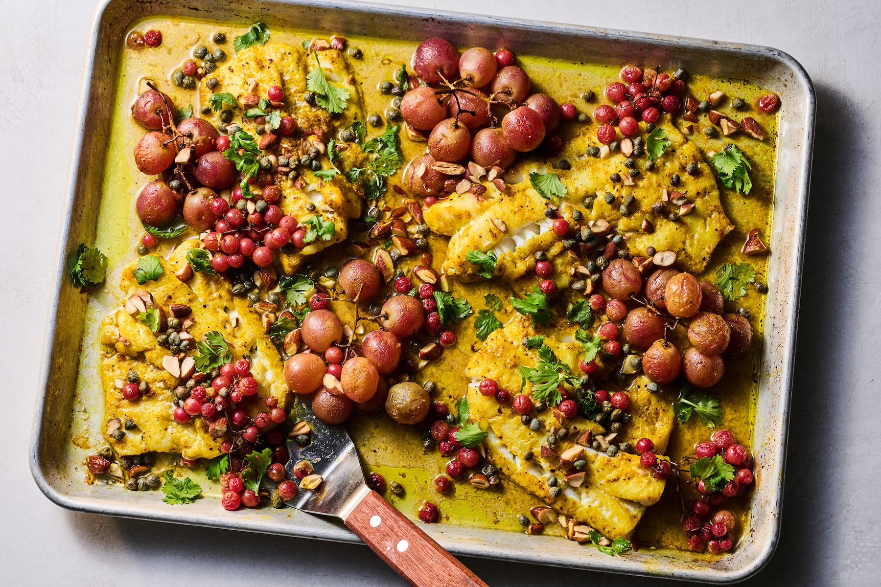Roasted turmeric fish and grapes