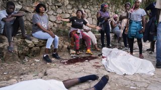 Mourners file into a church in Haiti where gangs killed dozens of people in latest rampage