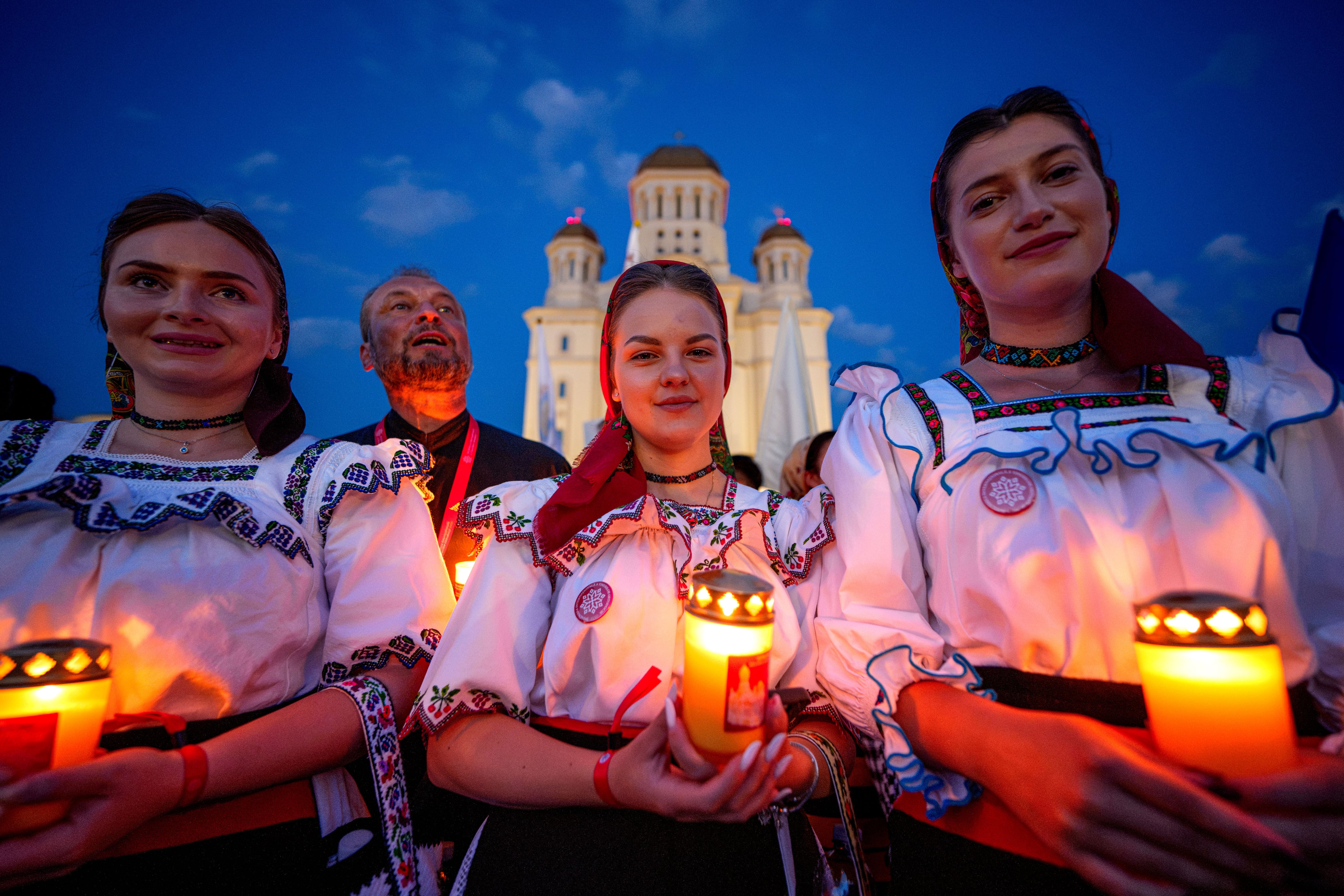 Photos of young Orthodox Christians taking part in a lights procession in Romania’s capital