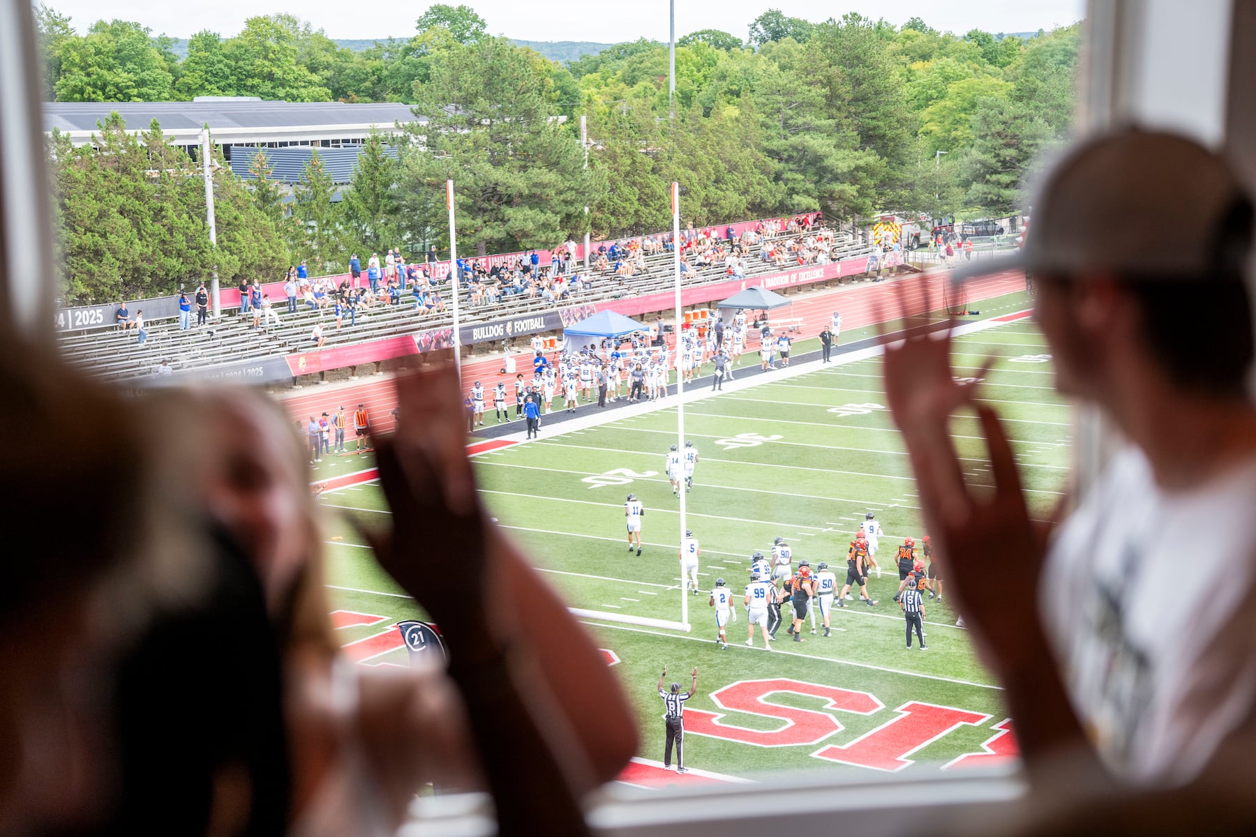 Ferris State students watch the first home game of the season from their dorm room windows