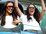 Maya Jama delightedly throws her hands in the air and flashes a glimpse of her midriff as she cheers on the teams at the Women's Super League football match