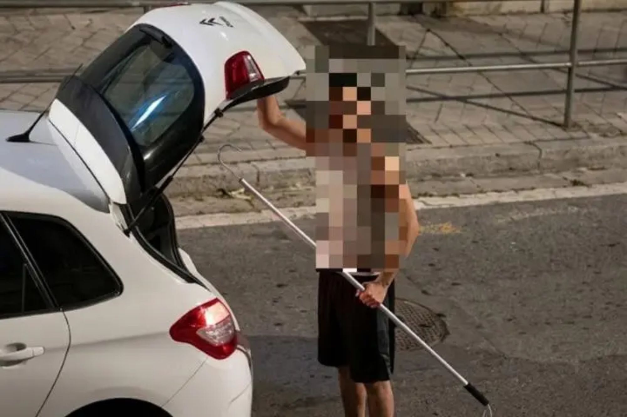 Horrifying moment driver attacks pedestrian with HARPOON before hooking him to metal railing in road rage confrontation