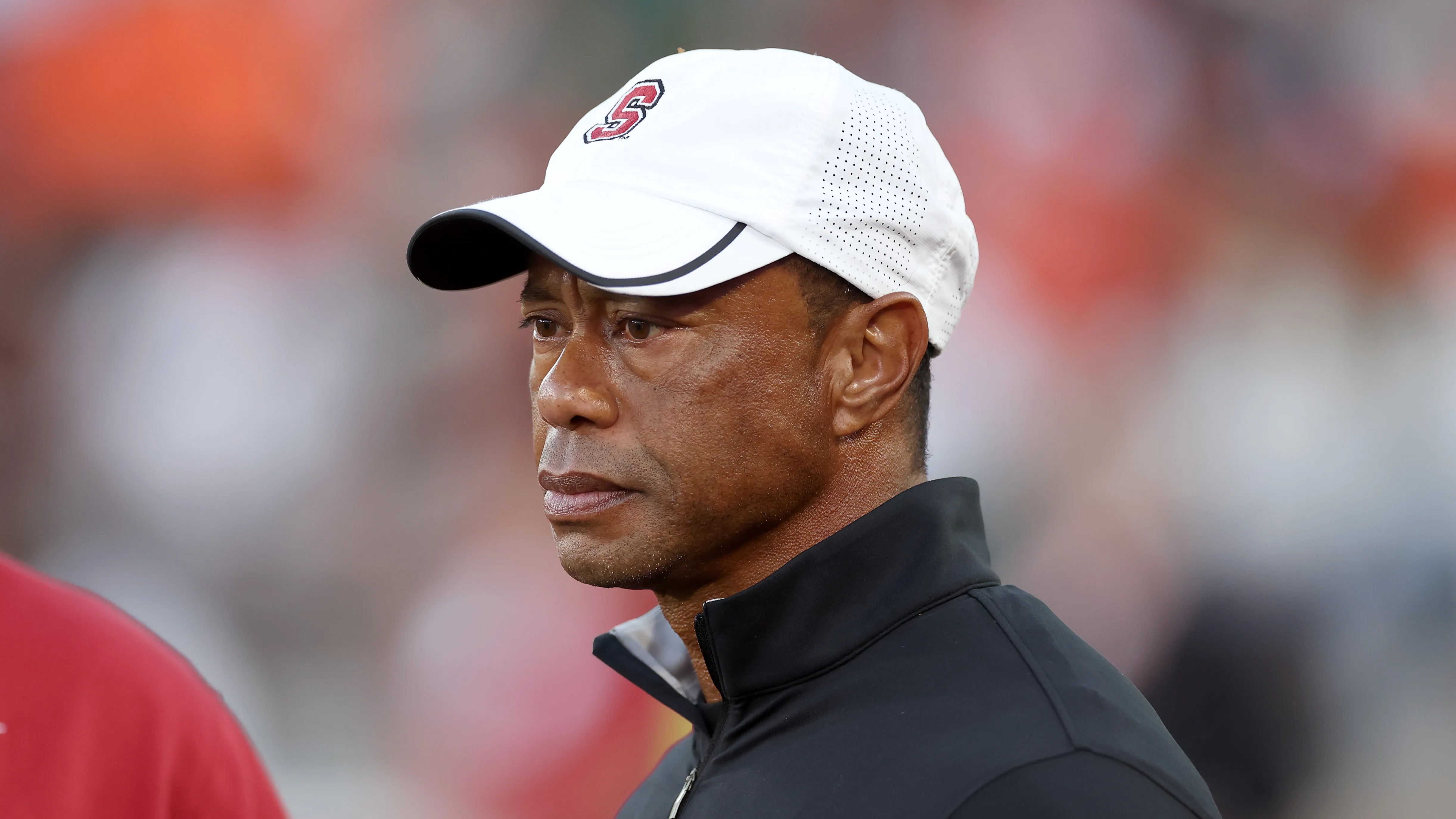 Tiger Woods makes first public appearance on sidelines at college football game since five-year driving ban punishment