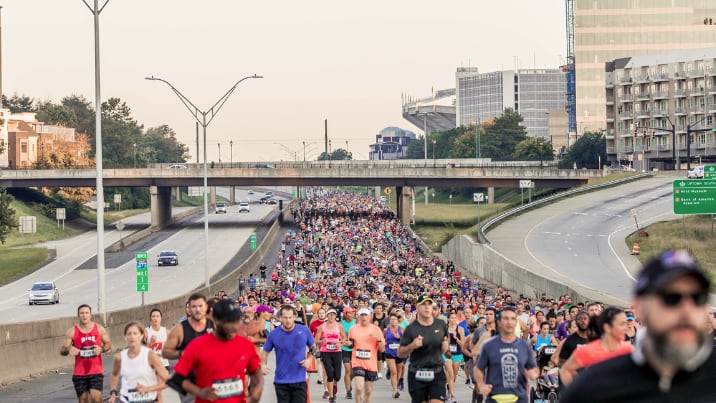 Thousands of runners shut down I-277 for Around the Crown 10K race
