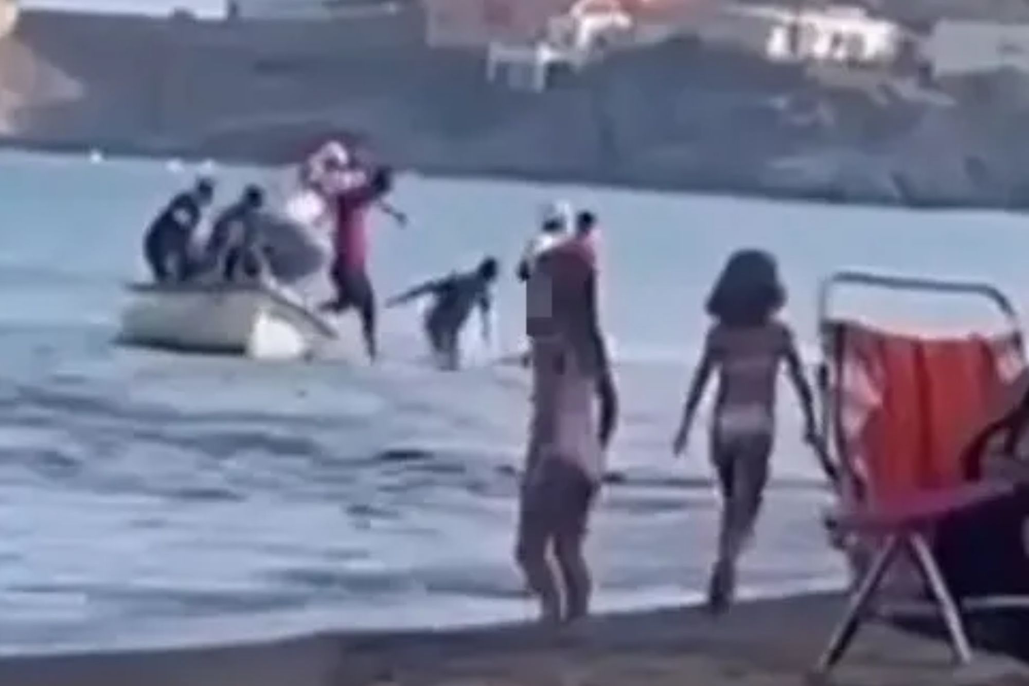 Migrant ‘taxi boat’ arrives at popular Spanish beach before men jump off and wade to shore in front of stunned tourists
