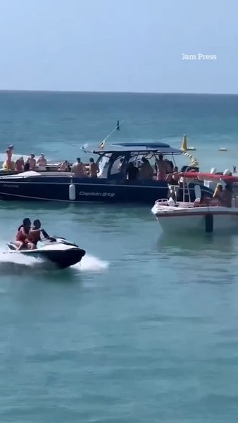 Jet ski sends holidaymakers flying after slamming into sightseeing boat in popular tourist spot