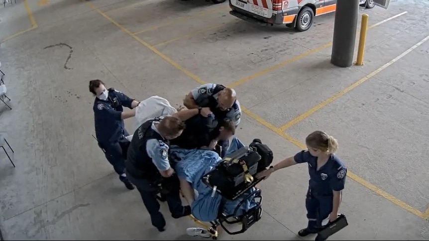 Officer who hit man on hospital stretcher keeps job with NSW Police
