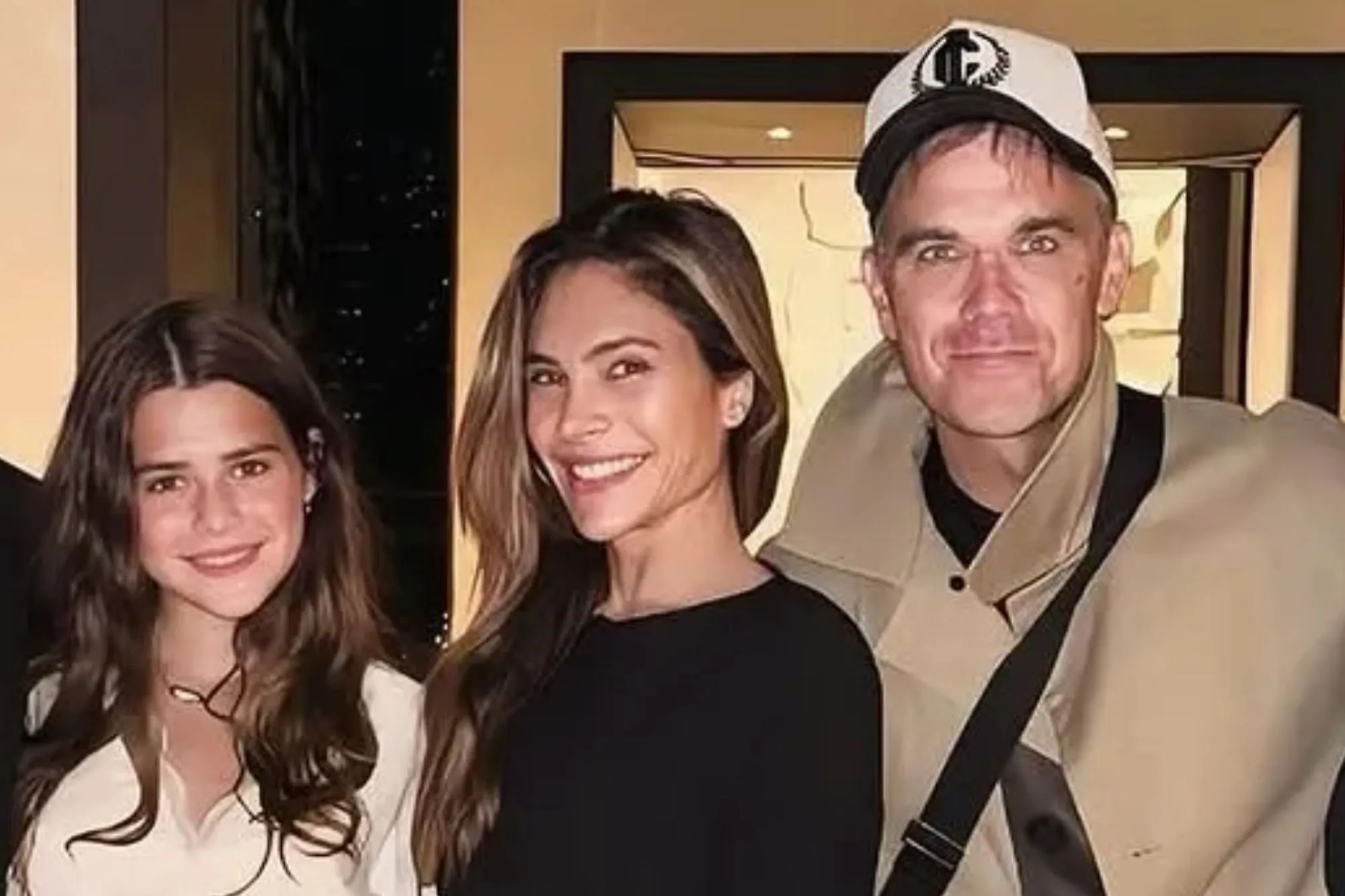 Proud parents Robbie Williams and Ayda Field beam beside daughter Teddy, 13, in a rare family snap in Paris