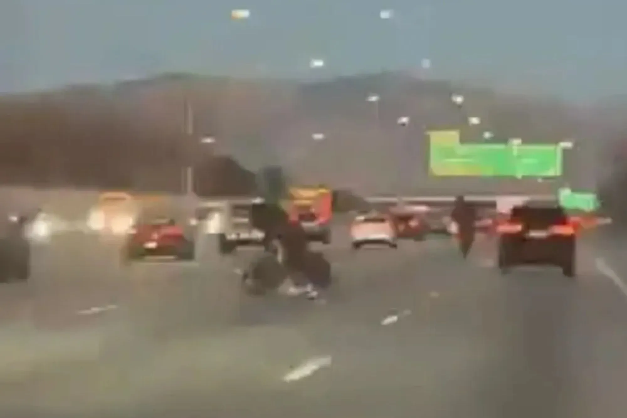 Shocking moment two motorcyclists perform dangerous stunt in middle of busy highway and get instant karma