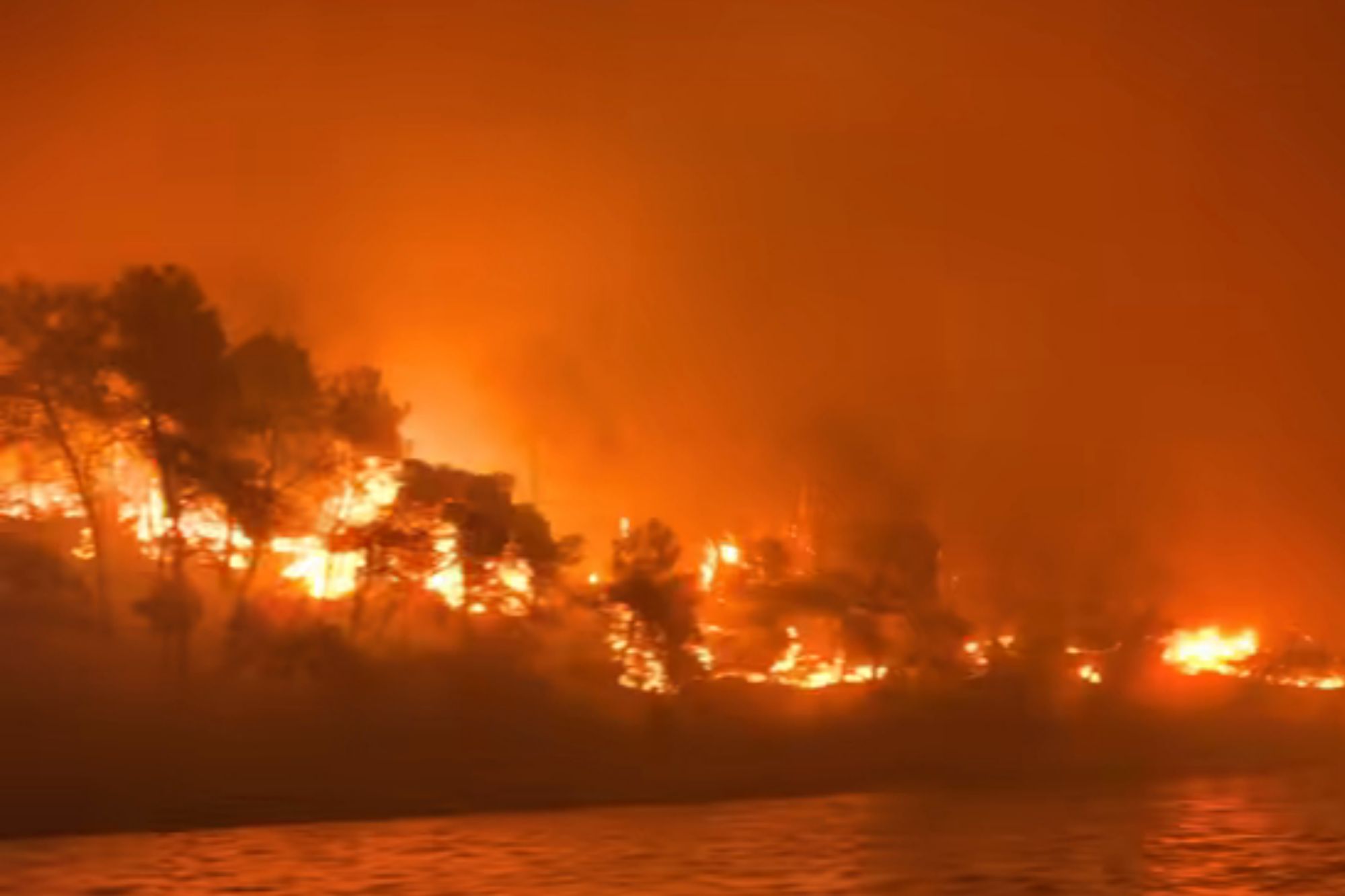 Terrifying moment Brit tourists flee wildfires on little boats in Dunkirk-style evacuation from holiday island inferno