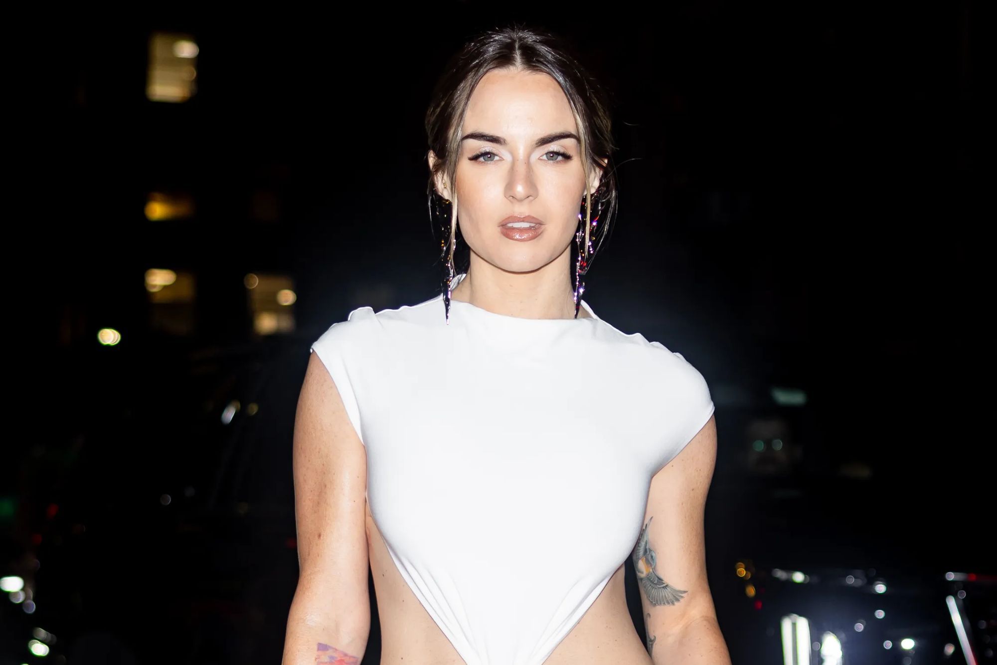 Noughties pop star looks unrecognisable as she flashes toned tum & tattoos at New York Fashion Week – can you guess who?