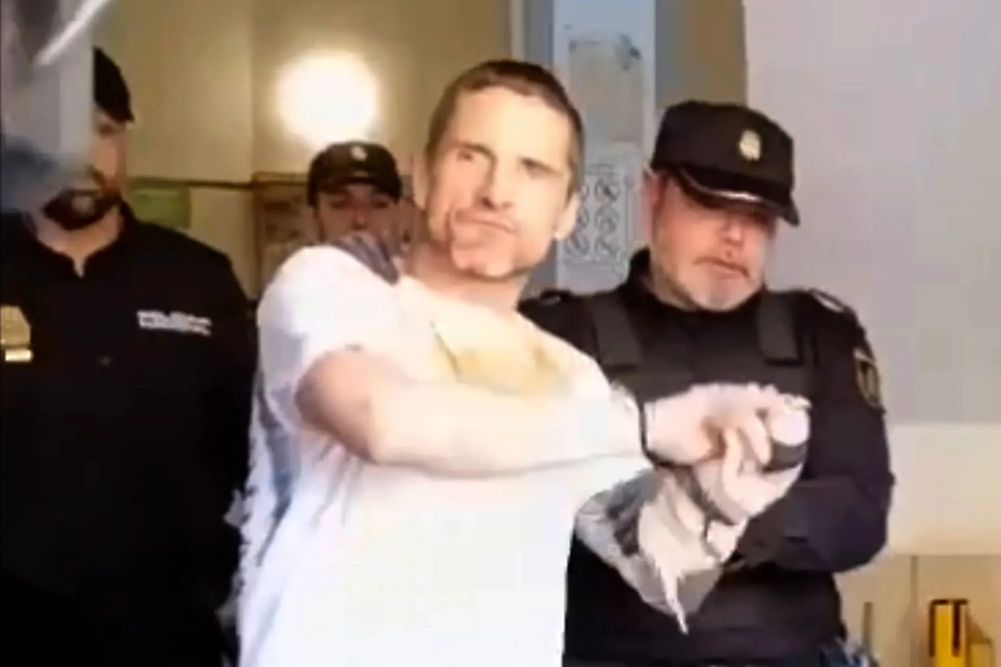 Handcuffed Brit shouts ‘f**k off’ as he & partner face 10 years in jail after ‘trying to kidnap woman’ on Spanish island