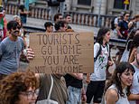 Not welcome! The tourist hotspots turning against visitors - from protests and graffiti to soaring taxes for holidaymakers
