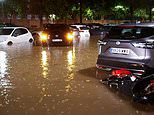 Streets are submerged by floods in Spain following country's hottest summer on record: Rescuers scramble to save woman washed away