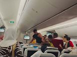 Two men throw punches at each other during flight from Bangladesh to London, with one man losing his T-shirt during the brawl