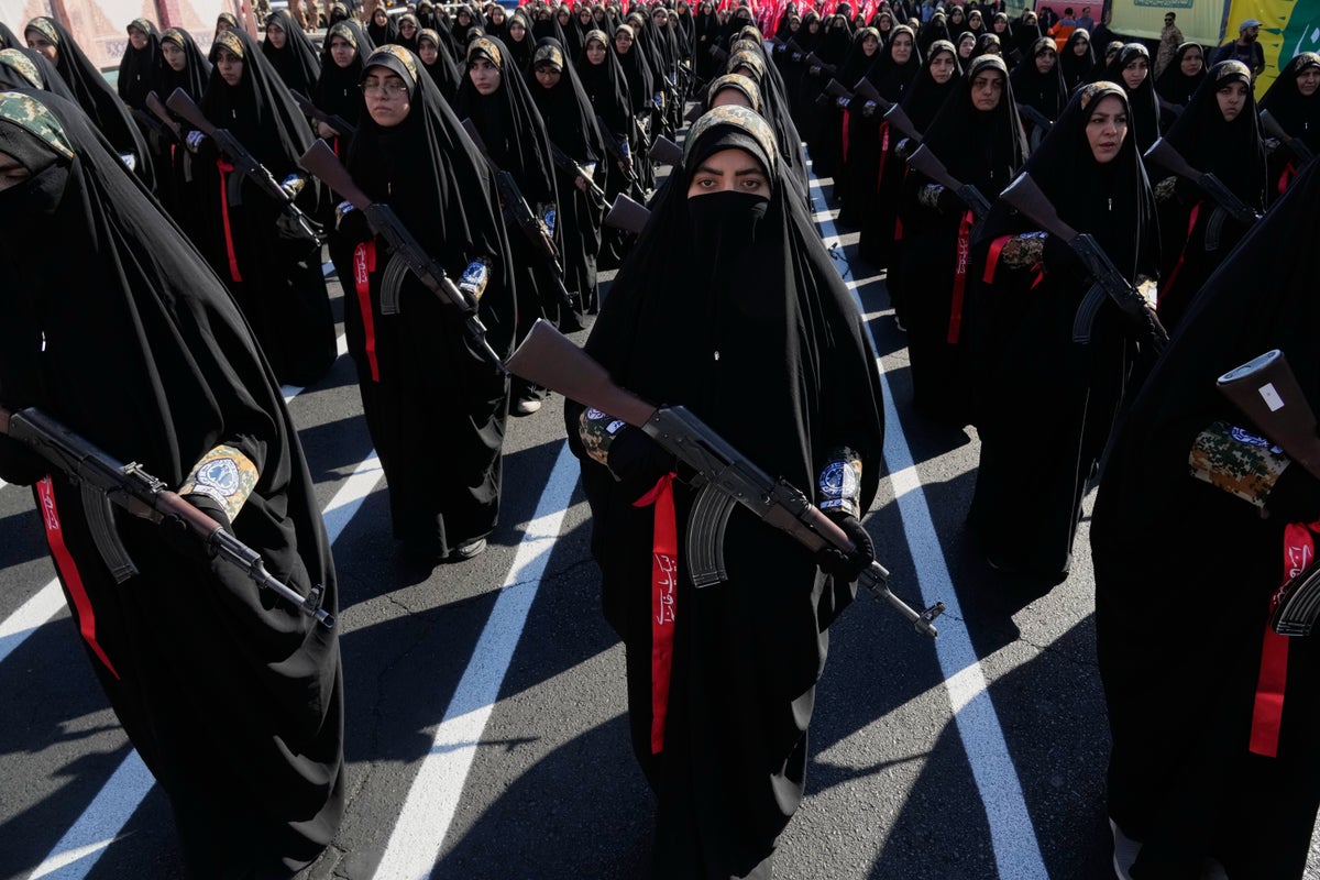 Iran stages massive Tehran rally as volunteers pledge to take up arms, in photos