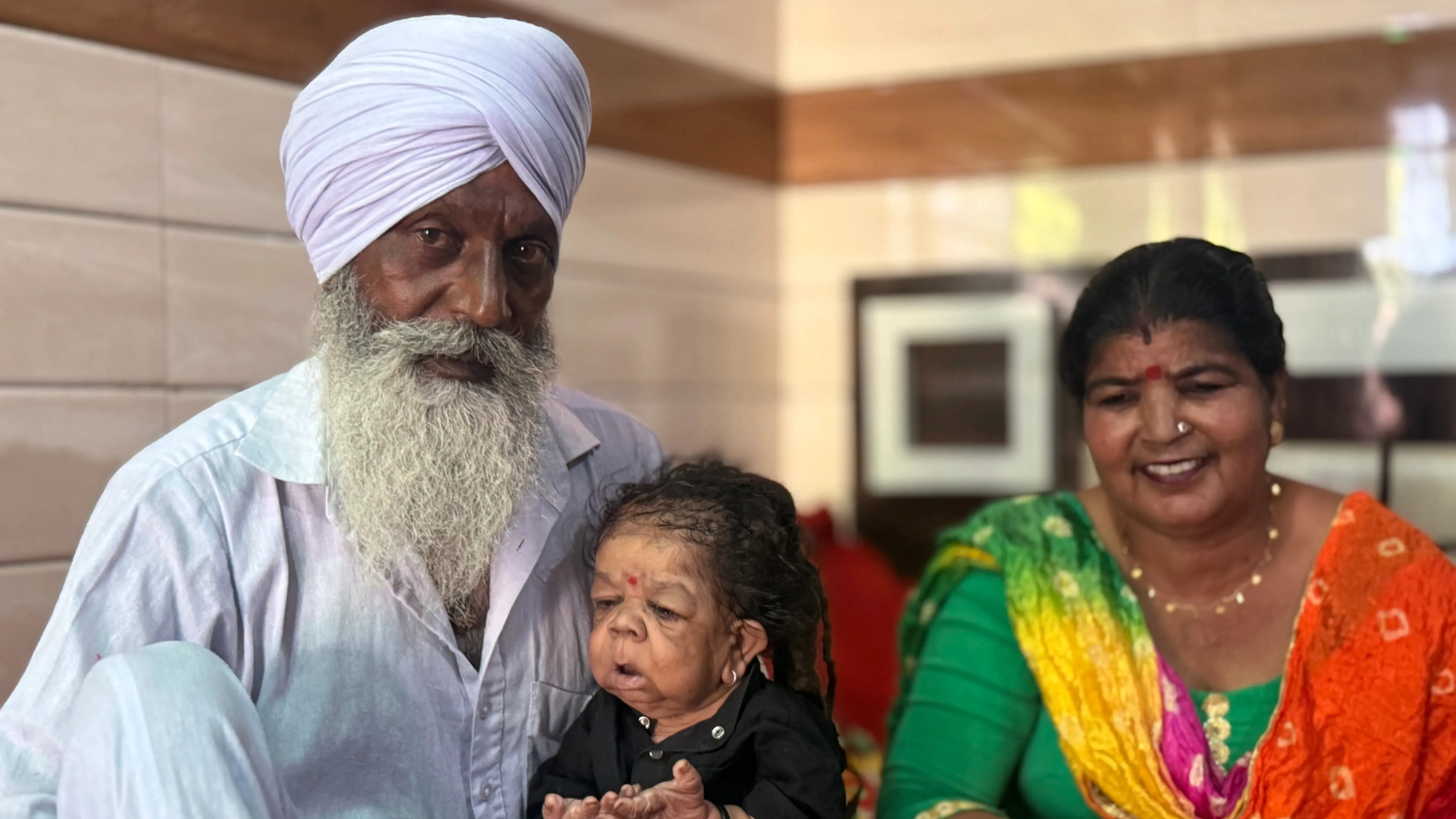 Man, 31, trapped in baby’s body stopped growing before turned one – people travel from across the world for his blessing