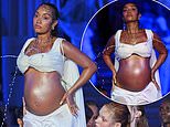 Pregnant Leigh-Anne Pinnock bares her baby bump and draws audible gasps from the crowd as her body becomes a fountain at the Di Petsa London Fashion Week show