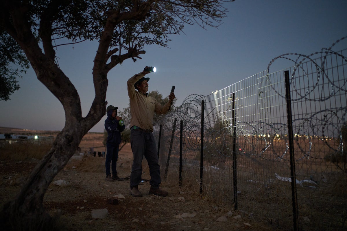 A flashlight and unseen settlers: Photographer conveys West Bank family's nightly watch in 1 photo