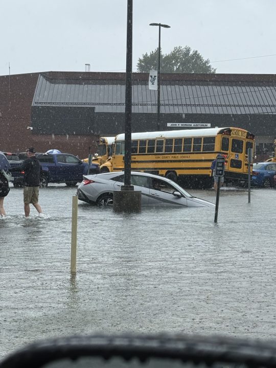 Vehicle partially submerged in flooded York High School parking lot