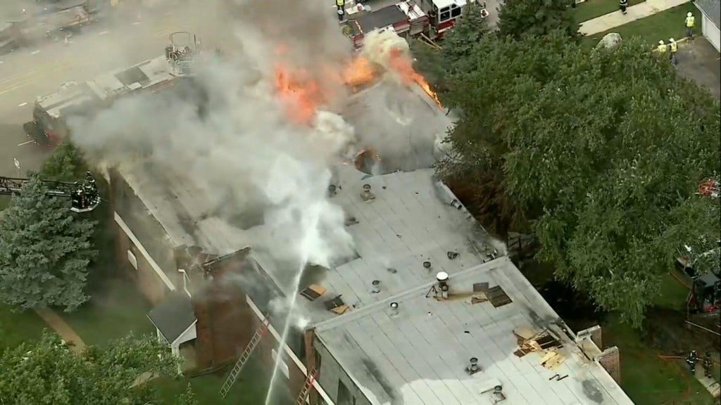 Woodridge fire shuts down Woodward Avenue, flames seen through roof of residential building