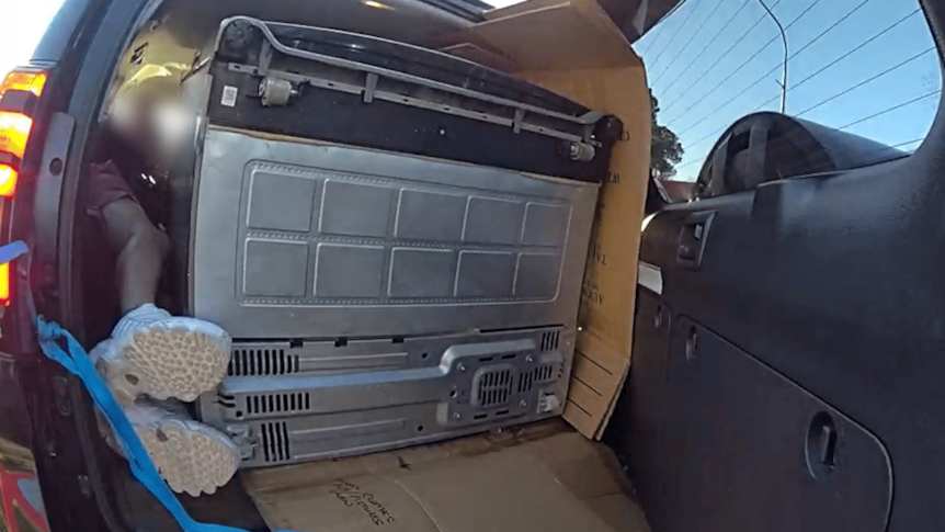 'We can see your feet': Man fined for lying next to fridge in car boot