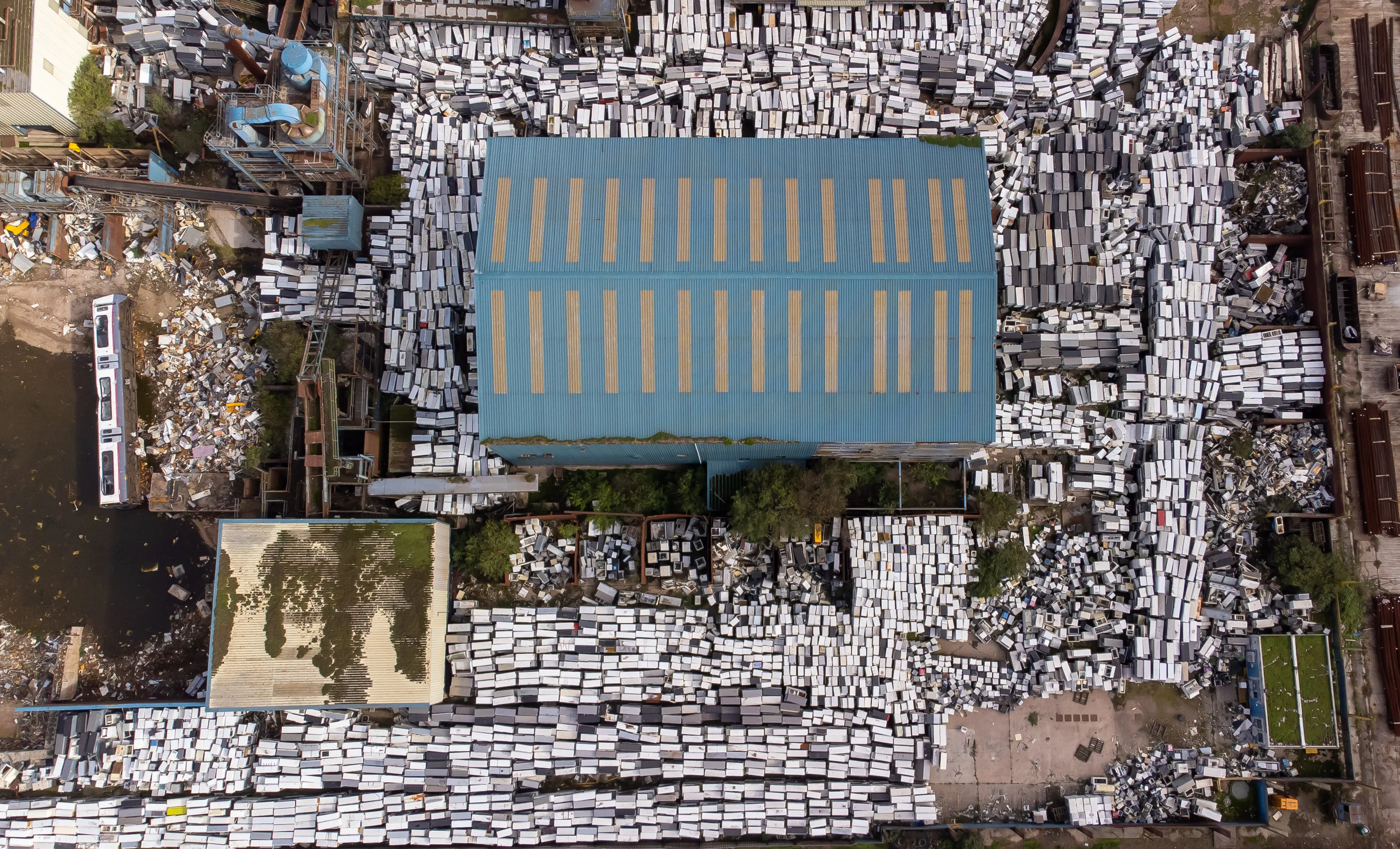 Massive pile of 80,000 dumped FRIDGES sits abandoned at docks after firm goes bust sparking council fury