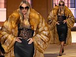 Rosie Huntington-Whiteley takes centre stage on the Gucci catwalk in sheer lace top and oversized fur coat during Milan Fashion Week