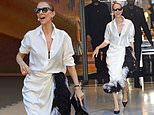 Celine Dion looks fashion forward in a white feathered skirt and blouse as she leaves hotel in Paris ahead of gig