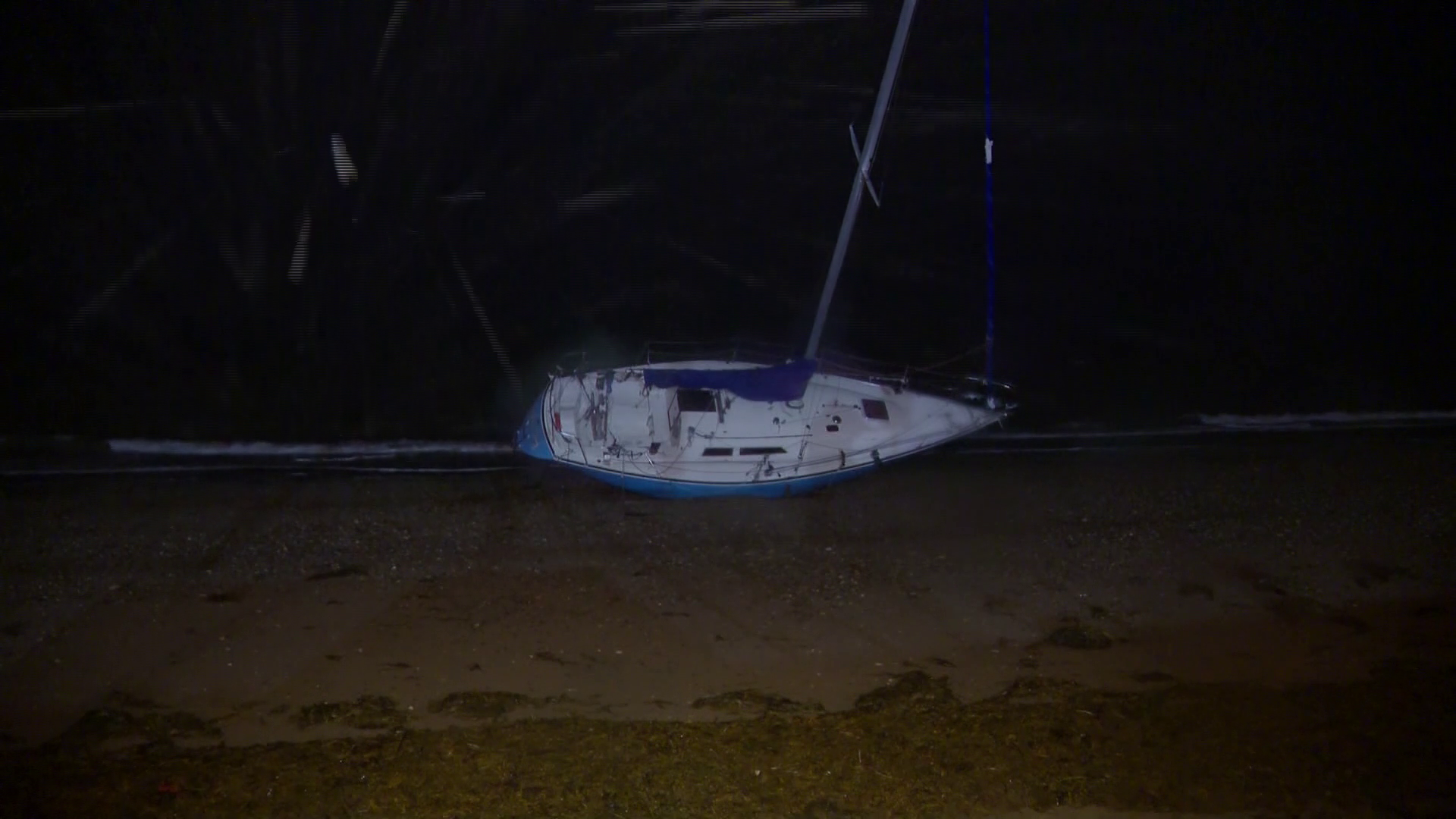 Sailboat washes ashore on Wollaston Beach in Quincy