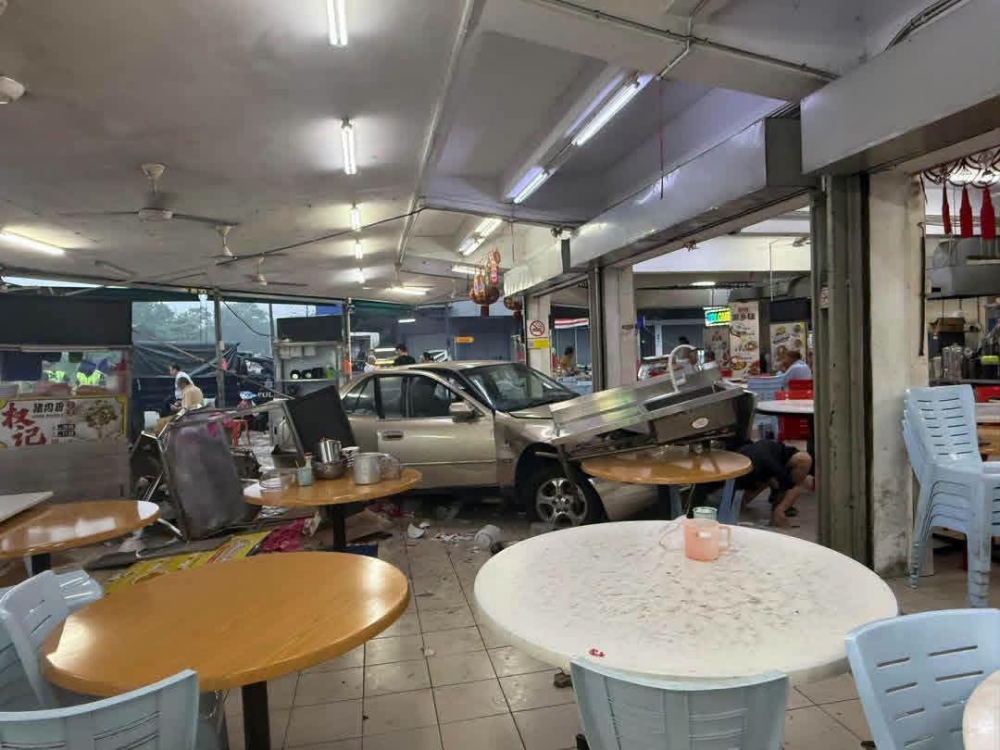 In Johor Bahru, man’s reversing mishap sends car into two vehicles and an eatery