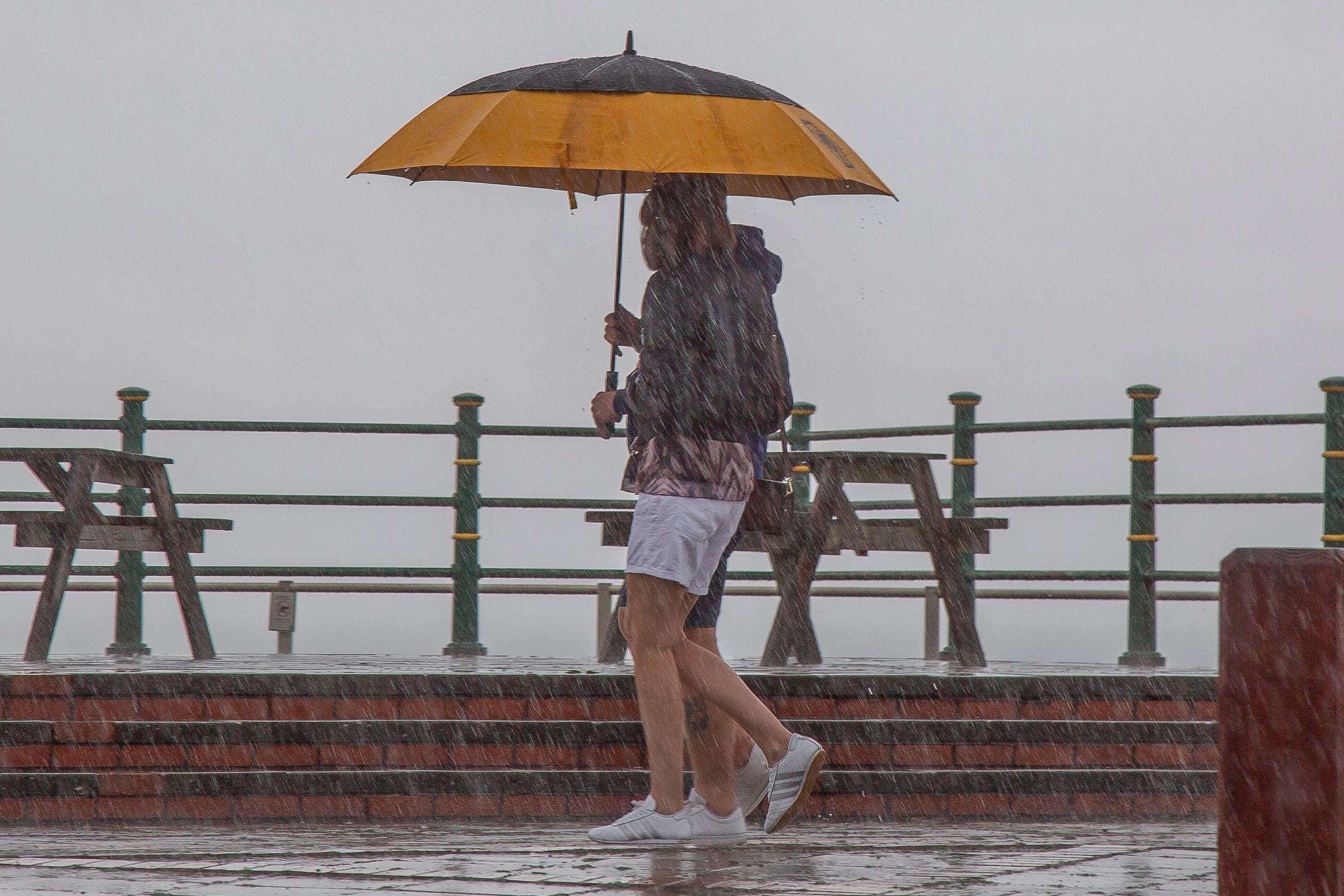 UK weather: Heavy rain, thunder and hail to batter Britain along with 50mph winds – but balmy autumn temps continue