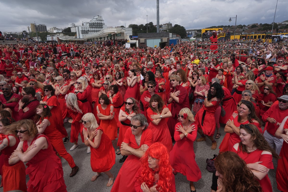 Hundreds of Kate Bush fans don red dresses for iconic Wuthering Heights dance