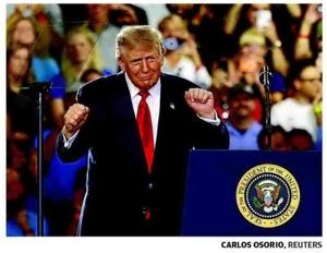 Trump uses GM stage to attack Dems