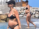 Pregnant Vogue Williams shows off her bump in a tiny bikini as she enjoys a dip in the sea while on holiday in Spain