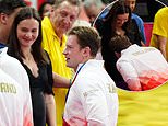Adam Peaty kisses pregnant wife Holly Ramsay's baby bump as he celebrates winning a silver medal for the 4x100m relay at the Commonwealth Games