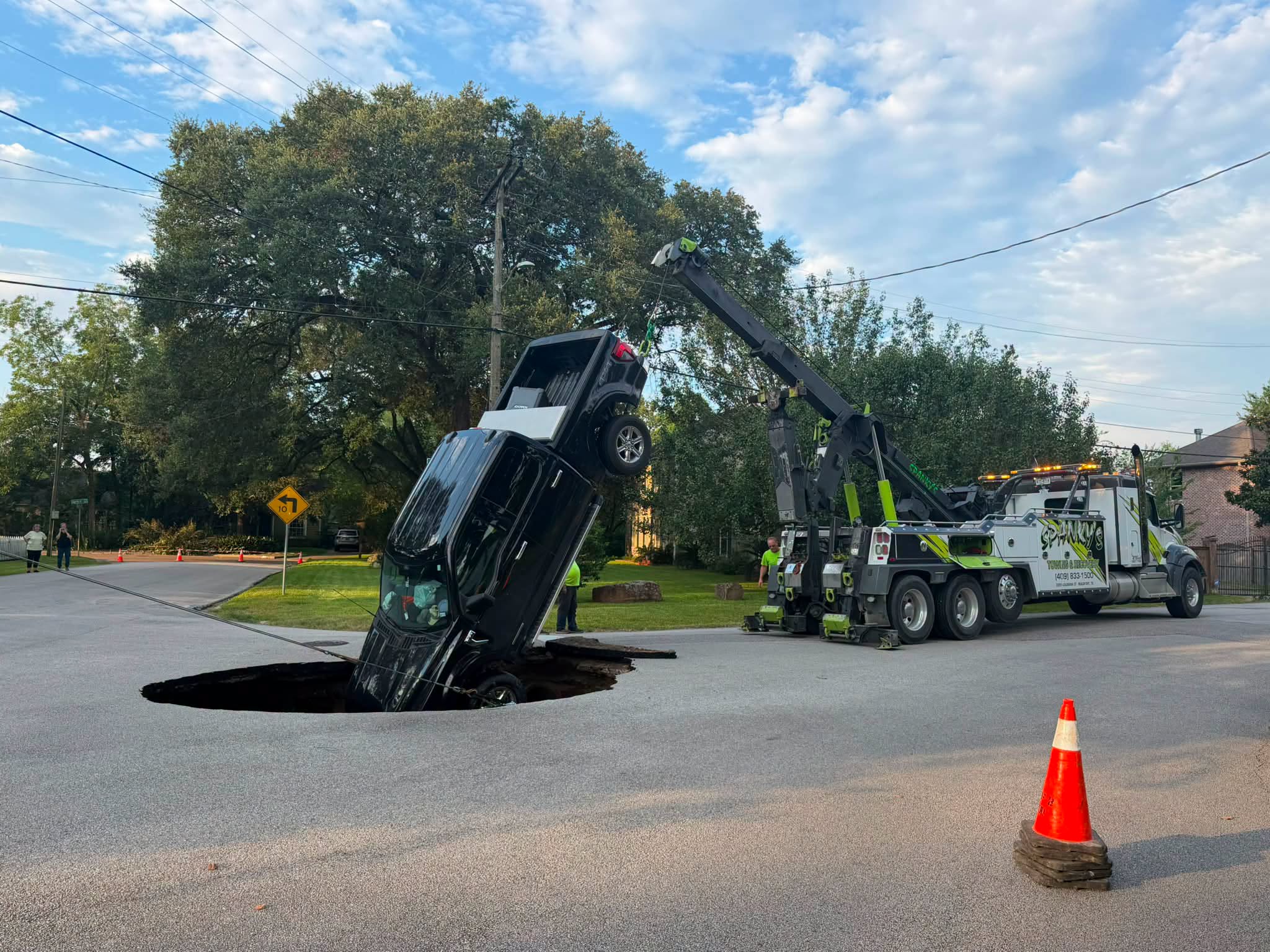 Pickup truck swallowed by road collapse following major water main break in Beaumont