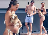 Charles Leclerc's wife Alexandra shows off her 'baby bump' in a black thong bikini as she joins him and their miniature dachshund on a £15million yacht in Sardinia