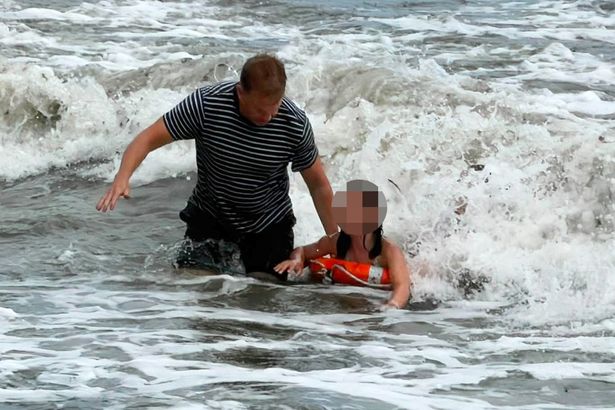 Moment seaside cafe owner saves drowning children by throwing life rings