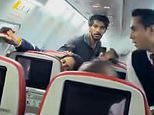 Terrifying moment plane passenger tried to open emergency exit at 30,000 feet 'because he felt like it' as he is arrested for attempted murder of his fellow flyers