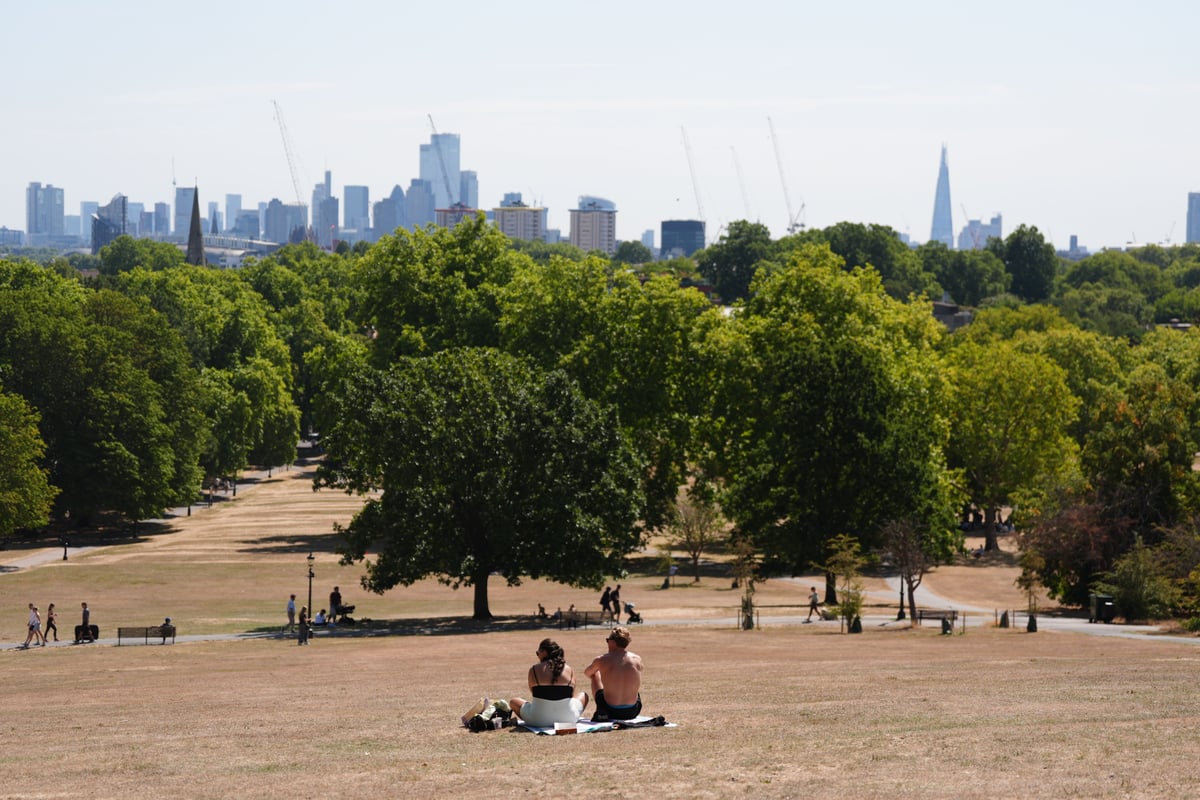 Temperatures rise to 30C while Scotland hit by half a month’s rain in two days