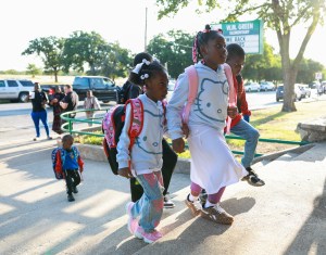 Parents stopped at the sidewalk outside a school. Inside, a new era for FWISD began