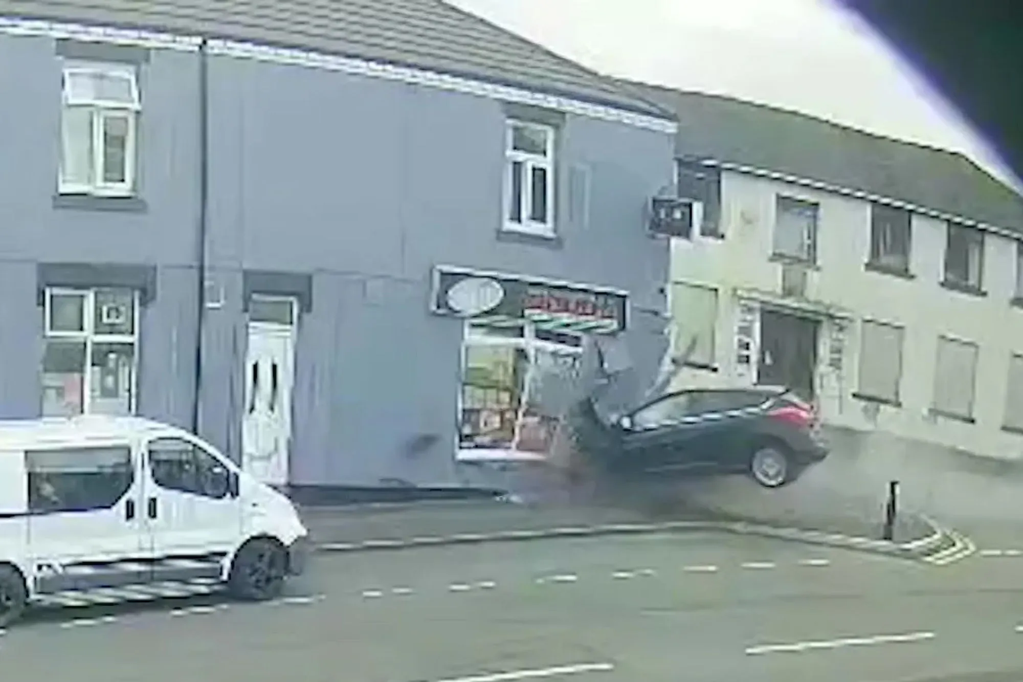 Shocking moment man, 21, smashes car into kebab shop while using phone causing front of takeaway to collapse