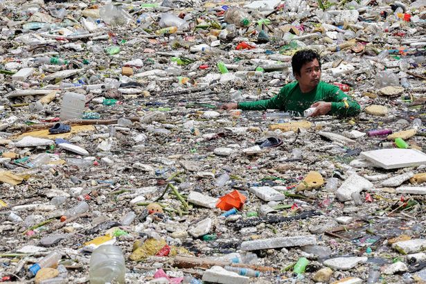 Rubbish collectors wade through sea of plastic after monsoon creates 'trash trap' in Manila