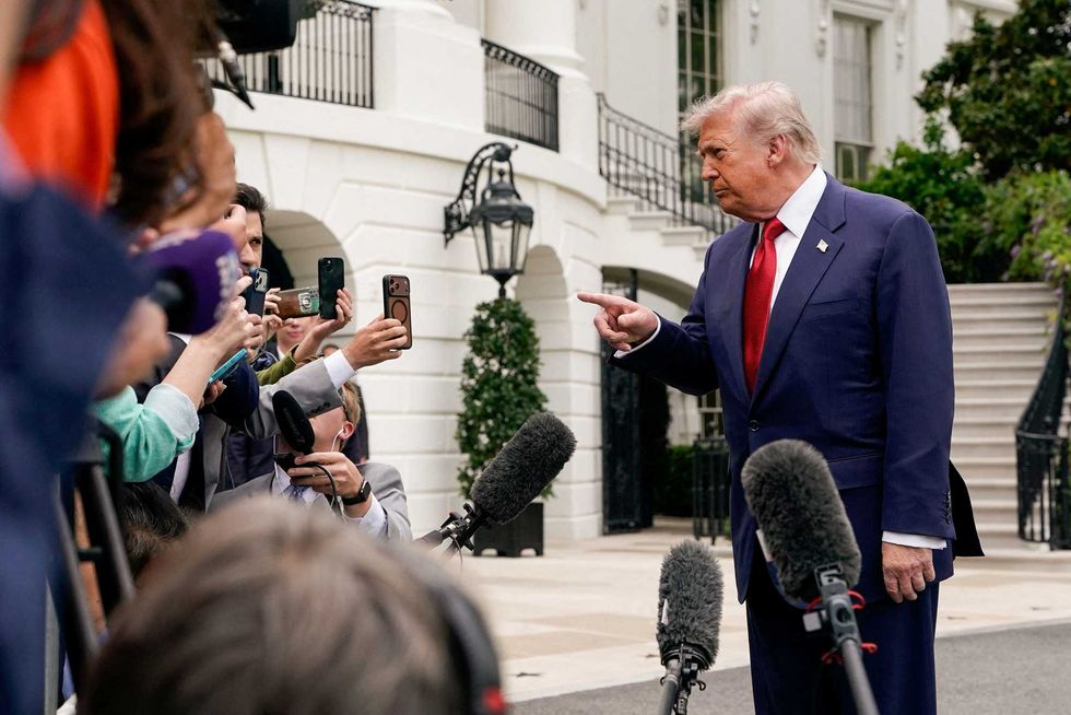 Trump fondles tree photos in front of baffled reporter: 'There is no precedent'