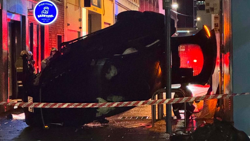 Driver treated for minor injuries after vehicle flipped on its side in Adelaide CBD