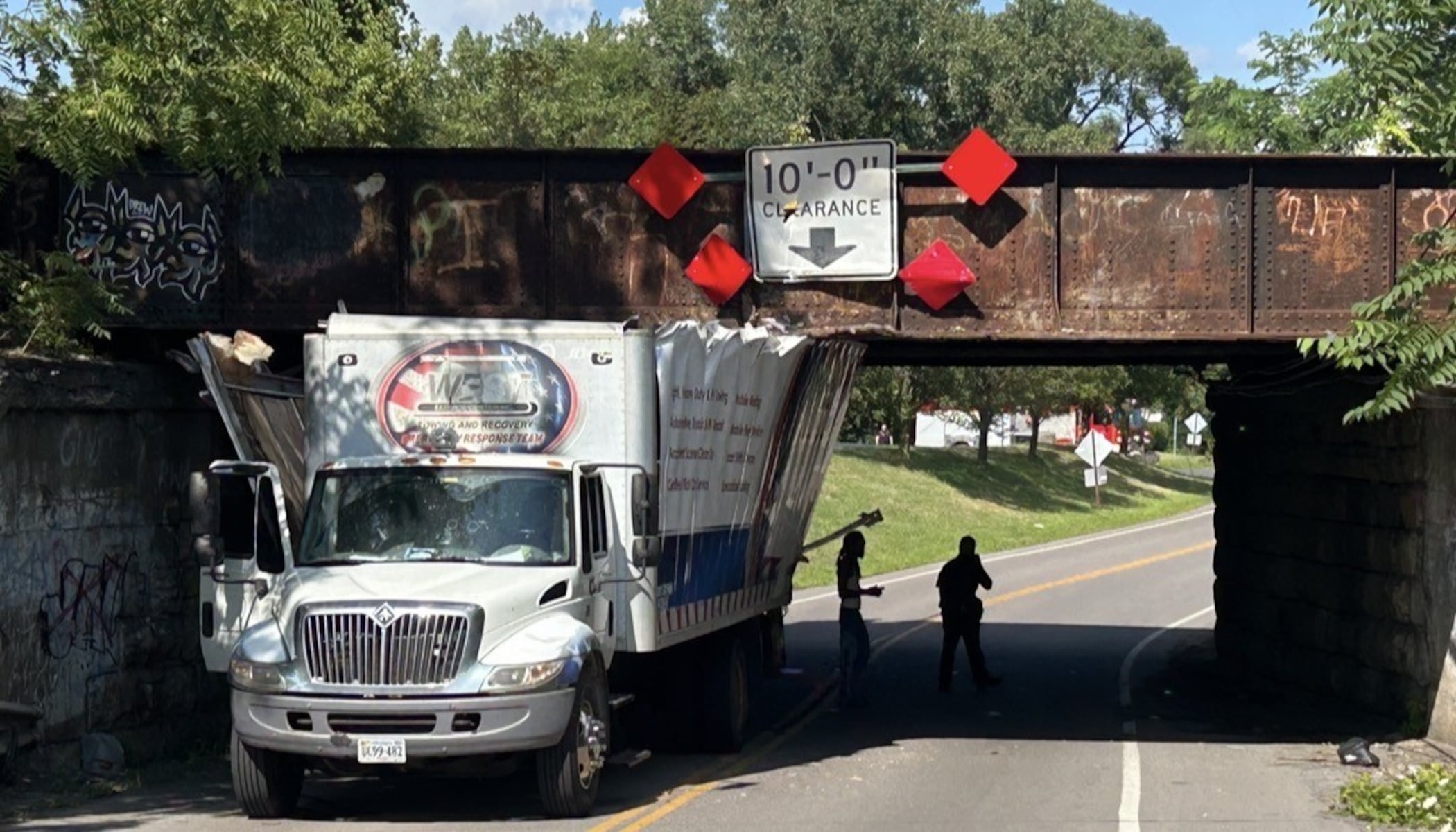 Box truck gets stuck under North Midler Avenue railroad bridge in DeWitt