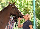Sealed with a kiss: Zara Tindall beams and jumps for joy after winning first major championship in nearly 20 years at the British Open Championships